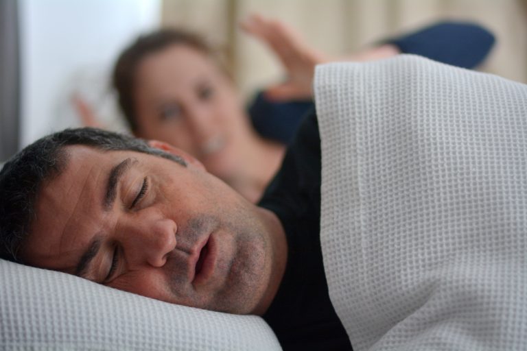 Woman suffers from her male partner snoring in bed