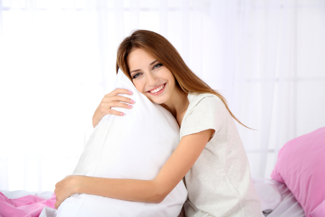woman hugging pillow - featured image